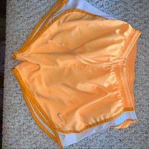 Orange Nike running shorts